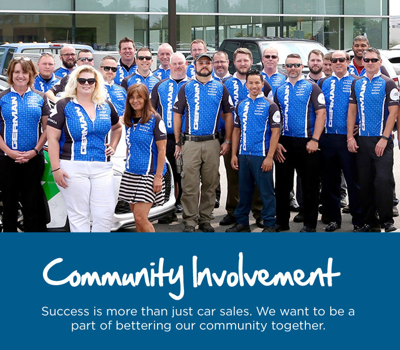 Text reads, “Community Involvement. Success is more than just car sales. We want to be a part of bettering our community together.” A group of people wearing matching cycling jerseys stand together outdoors in front of vehicles.