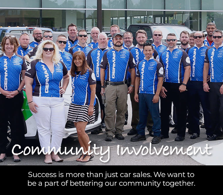 Group of Germain employees wearing matching blue jerseys outside a dealership. Text reads: "Community Involvement – Success is more than just car sales. We want to be a part of bettering our community together."